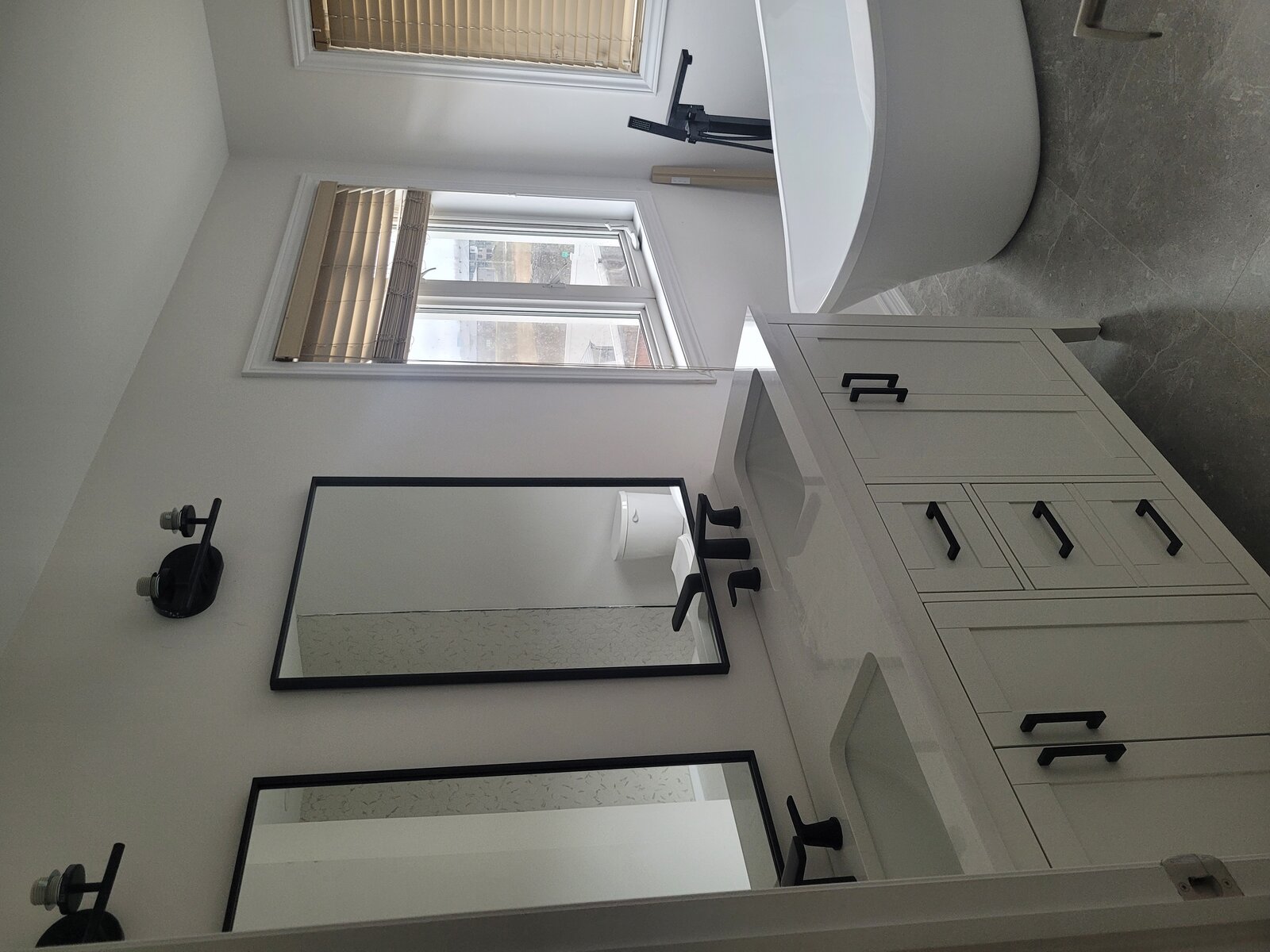 Double vanity with mirrors and modern fixtures
